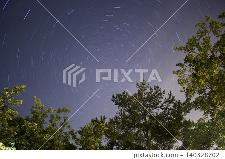 Star trails creating concentric circles in dark night sky Star trails creating concentric circles in dark night sky 140328702