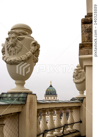 Rooftop view of the New German Cathedral golden adorned Dome in Berlin from the French Church terrace, showing contrast between historical and modern architecture, Foggy cloudy day. Copy space Rooftop view of the New German Cathedral golden adorned Dome in Berlin from the French Church terrace, showing contrast between historical and modern architecture, Foggy cloudy day. Copy space 140328889