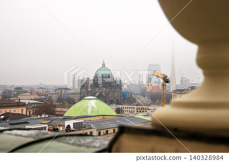 Berlin skyline with historic and modern sights. Panoramic birds eye view of foggy Berlin from the rooftop of French Church. Historic and modern landmarks on a misty day. Copy space 140328984