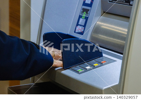 Closeup of person hand entering pin on a concealed atm keyboard. Secure keypad of cash machine. Confidentiality, privacy, reliability, security, and and secure banking concept Closeup of person hand entering pin on a concealed atm keyboard. Secure keypad of cash machine. Confidentiality, privacy, reliability, security, and and secure banking concept 140329057