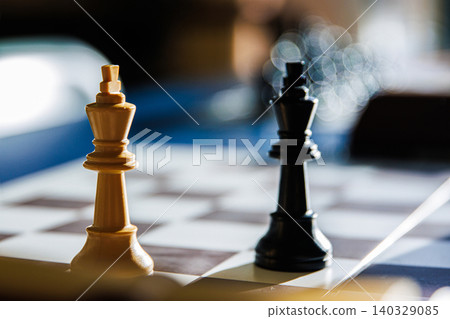 Dramatic chess endgame with two black and white lonely kings, symbolizing stalemate, board games strategy, intellectual challenge of decision making, isolation and loneliness of leadership. Soft focus Dramatic chess endgame with two black and white lonely kings, symbolizing stalemate, board games strategy, intellectual challenge of decision making, isolation and loneliness of leadership. Soft focus 140329085