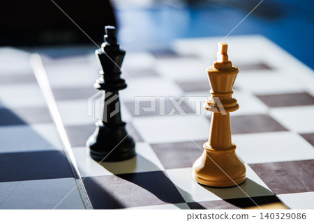 Dramatic chess endgame with two black and white lonely kings, symbolizing stalemate, board games strategy, intellectual challenge of decision making, isolation and loneliness of leadership. Soft focus Dramatic chess endgame with two black and white lonely kings, symbolizing stalemate, board games strategy, intellectual challenge of decision making, isolation and loneliness of leadership. Soft focus 140329086