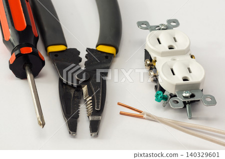 Electrical outlet, screwdriver and wire stripper tools on white background Electrical outlet, screwdriver and wire stripper tools on white background 140329601