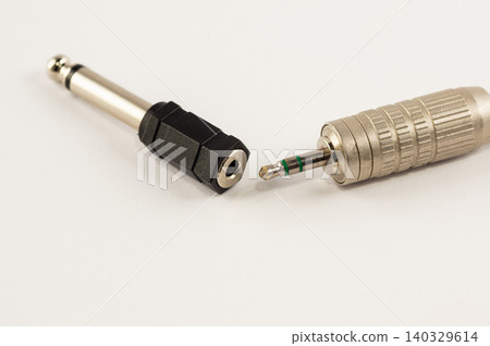 Mini-jack connector with adapter on a white background Mini-jack connector with adapter on a white background 140329614