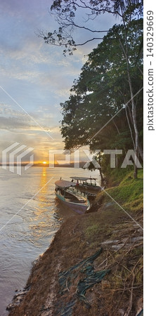 Wooden motorboats on the bank of a tropical river at sunset Wooden motorboats on the bank of a tropical river at sunset 140329669