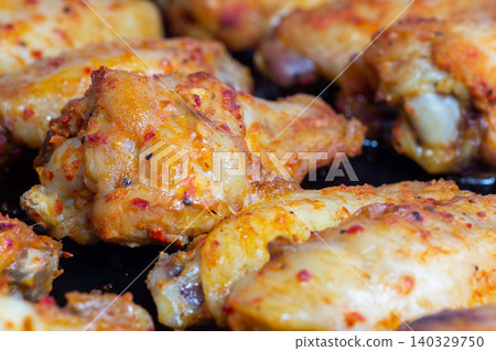 Grilled chicken leg quarters on a baking sheet. Close-up. 140329750