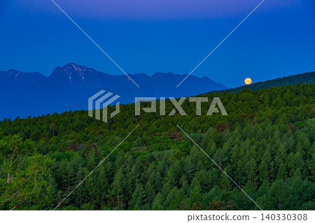 [Yamanashi Prefecture] Beautiful forest of Kiyosato with azaleas in bloom, distant view of the Southern Alps, setting moon 140330308
