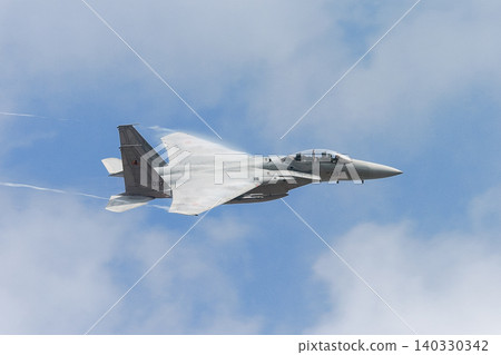 日本航空自衛隊F-15DJ鷹式戰鬥機的機翼在雲層之上閃耀。 日本航空自衛隊F-15DJ鷹式戰鬥機的機翼在雲層之上閃耀。 140330342