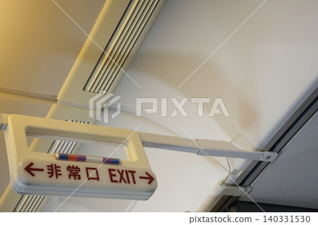 Emergency exit signs inside an airplane Emergency exit signs inside an airplane 140331530