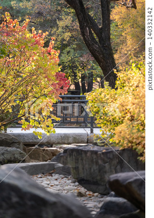View of Yeouido Park, stone path walkway with bridge on the background. Surrounded by colorful leaves tree, autumn foliage. It is a park in Yeongdeungpo District, Seoul, South Korea. View of Yeouido Park, stone path walkway with bridge on the background. Surrounded by colorful leaves tree, autumn foliage. It is a park in Yeongdeungpo District, Seoul, South Korea. 140332142