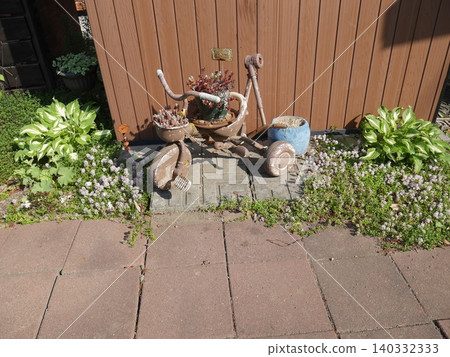 A bright garden accented by a tricycle. A bright garden accented by a tricycle. 140332333