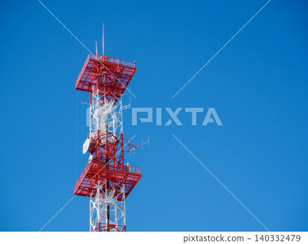 A television transmission tower soaring into the blue sky A television transmission tower soaring into the blue sky 140332479