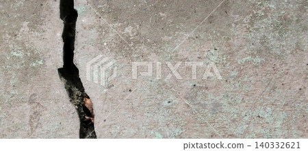Cracked concrete surface with visible structural and textural damage. Cracked concrete surface with visible structural and textural damage. 140332621