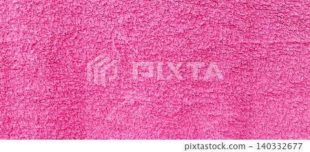 A close-up of the texture of the pink towel fabric, with soft fibers and clear surface details. A close-up of the texture of the pink towel fabric, with soft fibers and clear surface details. 140332677