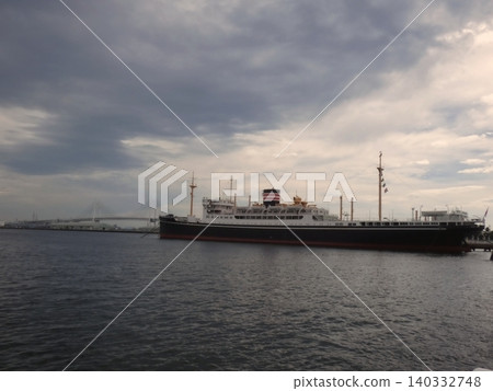 The Hikawa Maru docked in Yokohama Port and the view of the Bay Bridge. The Hikawa Maru docked in Yokohama Port and the view of the Bay Bridge. 140332748