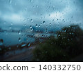 The view through a windowpane covered in raindrops 140332750