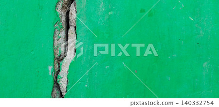 Cracked green concrete wall texture with structural damage details 140332754