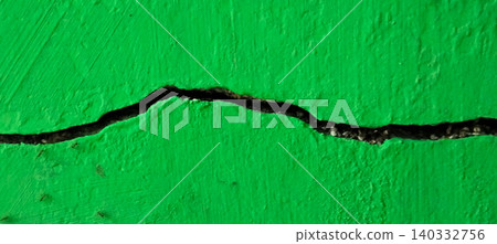 Cracked green concrete wall texture with structural damage details 140332756