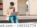 Students are doing research and finding knowledge on the internet on laptops in the university area. 140332774