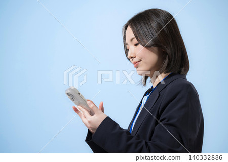 A businesswoman using her smartphone to search, find, inquire about, and check contacts, all against a light blue background. A businesswoman using her smartphone to search, find, inquire about, and check contacts, all against a light blue background. 140332886