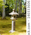 A stone lantern standing in a moss-covered garden 140333606
