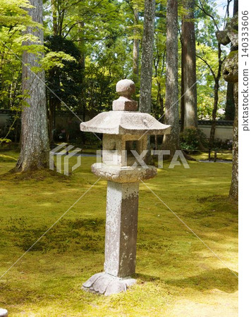 A stone lantern standing in a moss-covered garden A stone lantern standing in a moss-covered garden 140333606