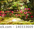 A tranquil pond with camellia flowers floating on it. 140333609