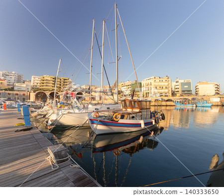Fishing Boats and Sailing Yachts Moored in Heraklion Marina Crete Greece Fishing Boats and Sailing Yachts Moored in Heraklion Marina Crete Greece 140333650