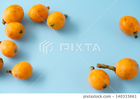 Irregularly shaped, organic, ripe loquats as background material | Natural imperfections and discoloration remain. Irregularly shaped, organic, ripe loquats as background material | Natural imperfections and discoloration remain. 140333661
