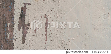Peeling and worn paint texture on a weathered wall background. Peeling and worn paint texture on a weathered wall background. 140333831