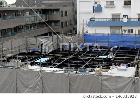 steel frame construction, Construction Workers Installing Steel Frame Structure at Urban Building Site steel frame construction, Construction Workers Installing Steel Frame Structure at Urban Building Site 140333928