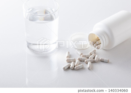A glass of water and supplements A glass of water and supplements 140334060
