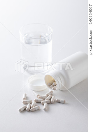 A glass of water and supplements A glass of water and supplements 140334067