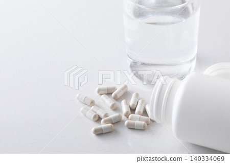 A glass of water and supplements A glass of water and supplements 140334069