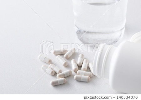A glass of water and supplements A glass of water and supplements 140334070