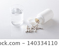 A glass of water and supplements 140334110