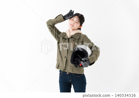 Female motorcyclist with helmet Female motorcyclist with helmet 140334316