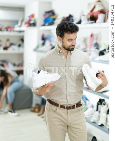 Adult man choosing sneakers at shoe store Adult man choosing sneakers at shoe store 140334712