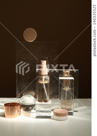 Three clear bottles on a table with light behind 140335525