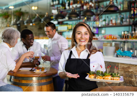 View on the Hispanic young lady holding tapas View on the Hispanic young lady holding tapas 140335679