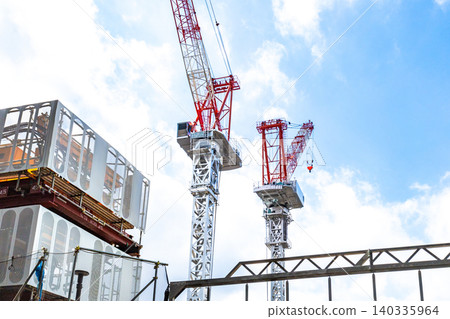 Large cranes and heavy machinery at construction sites 140335964