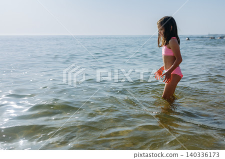 small girl going to swim in the Sea small girl going to swim in the Sea 140336173