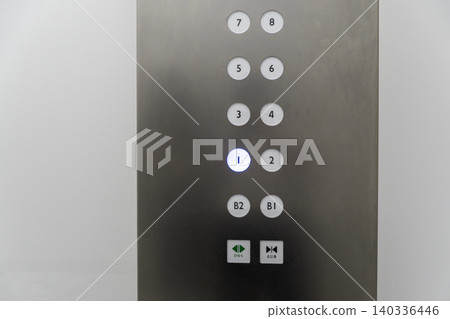 Close-up of the button panel of a stainless steel elevator. 140336446