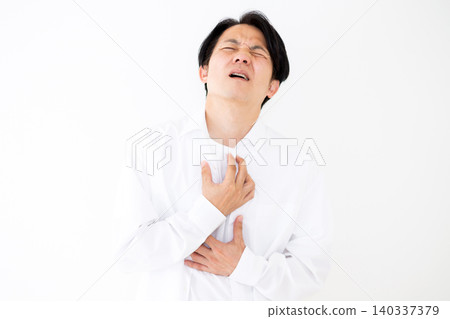 Middle-aged man suffering from chest pain Middle-aged man suffering from chest pain 140337379