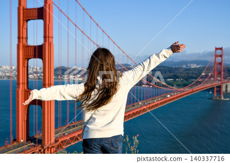 Woman with open arms above Golden Gate Bridge and San Francisco Bay Woman with open arms above Golden Gate Bridge and San Francisco Bay 140337716