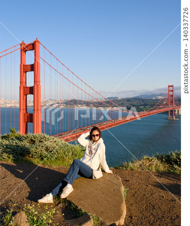 Woman at Golden Gate Bridge overlook with San Francisco Bay view 140337726