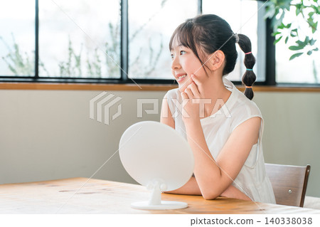 Elementary school and junior high school girls looking in the mirror (skin care, acne) 140338038