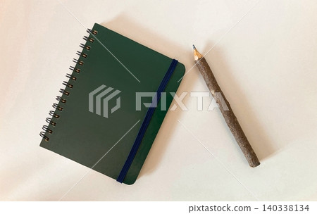 A ring notebook and a wooden pencil 140338134