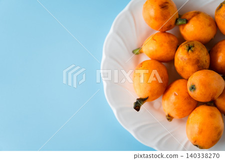 Irregularly shaped, organic, ripe loquats as background material | Natural imperfections and discoloration remain. Irregularly shaped, organic, ripe loquats as background material | Natural imperfections and discoloration remain. 140338270