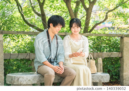 Young couples taking city walks and sightseeing tours on domestic trips 140339032
